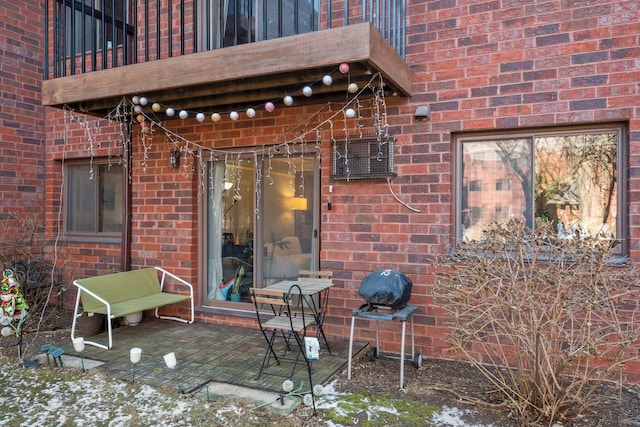 view of patio featuring a balcony