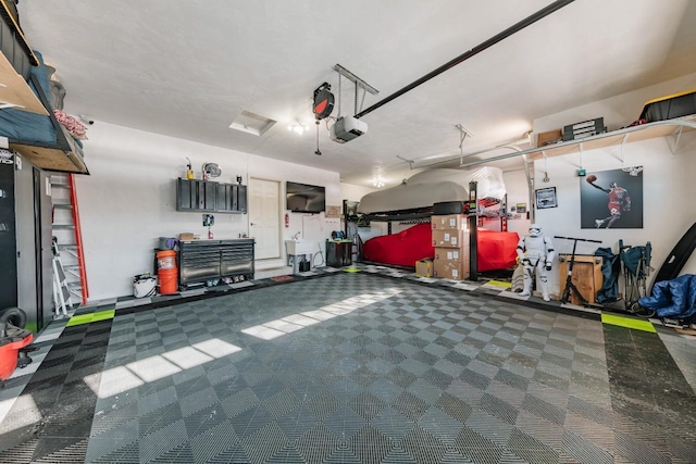 garage with a garage door opener and sink