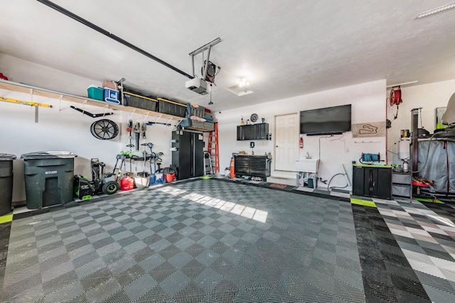 garage featuring sink and a garage door opener