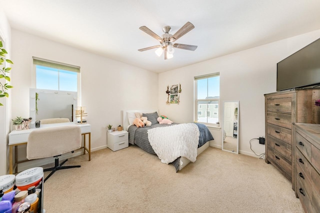 carpeted bedroom with multiple windows and ceiling fan