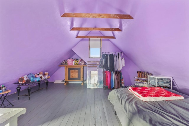 bedroom with hardwood / wood-style floors and lofted ceiling