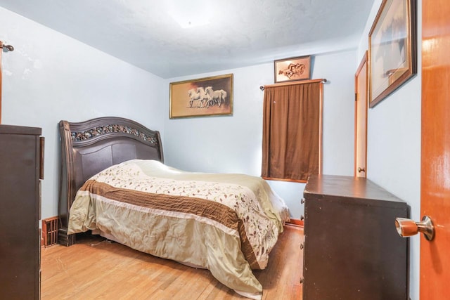 bedroom with wood-type flooring