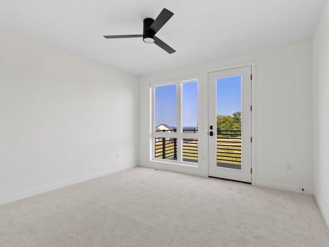 spare room with ceiling fan, light carpet, and french doors