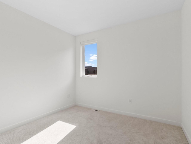 unfurnished room featuring light colored carpet