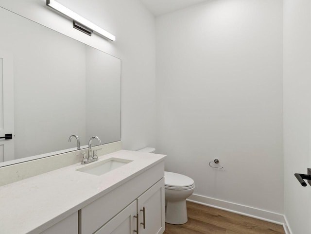 bathroom featuring hardwood / wood-style floors, toilet, and vanity