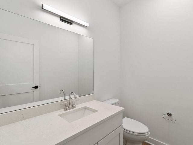 bathroom featuring toilet and vanity