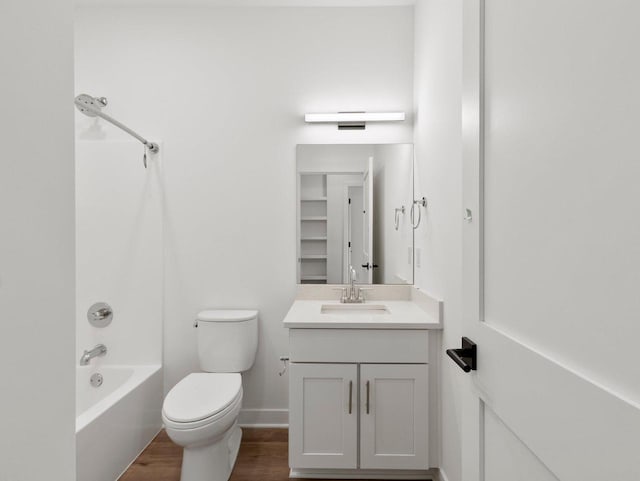 full bathroom with vanity, shower / tub combination, hardwood / wood-style floors, and toilet