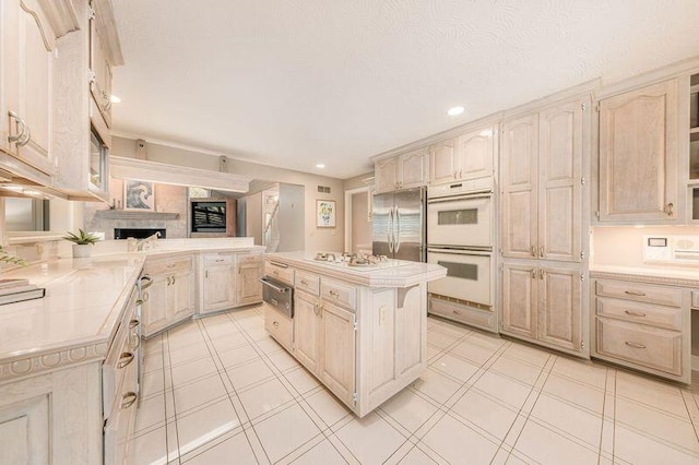 kitchen featuring white appliances, a center island, and kitchen peninsula