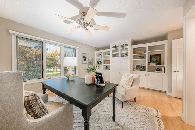 home office featuring ceiling fan and light hardwood / wood-style flooring