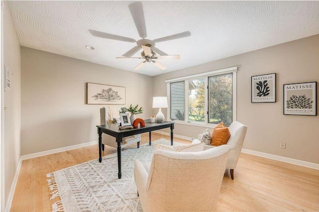 office area with light wood-type flooring and ceiling fan