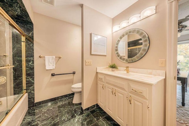 full bathroom featuring vanity, toilet, and enclosed tub / shower combo