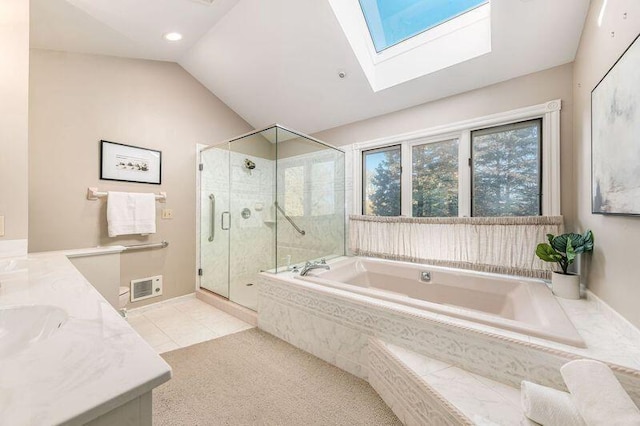 bathroom featuring separate shower and tub, vanity, tile patterned floors, and lofted ceiling with skylight