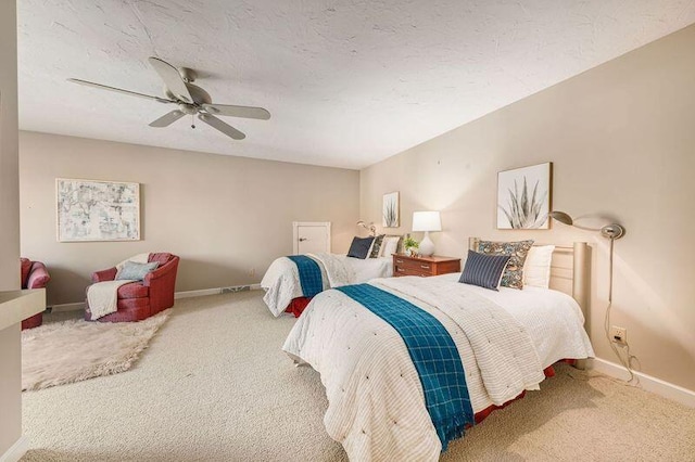 carpeted bedroom with ceiling fan and a textured ceiling