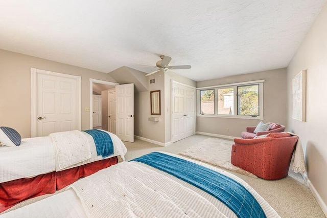 carpeted bedroom featuring a textured ceiling and ceiling fan