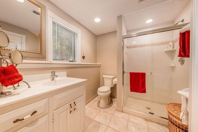 bathroom with tile patterned floors, an enclosed shower, vanity, and toilet