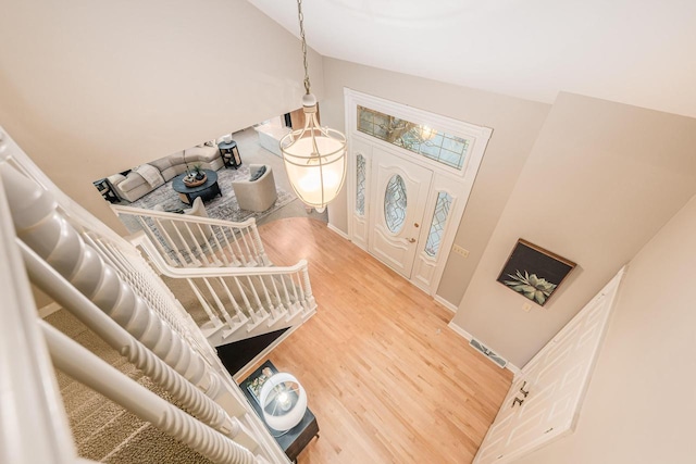 entryway with hardwood / wood-style flooring and lofted ceiling