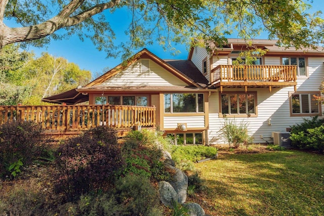 back of property featuring cooling unit, a deck, and a yard