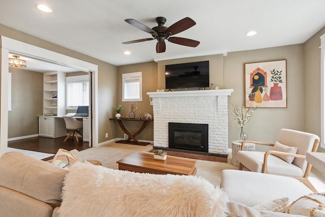 living room with ceiling fan, dark hardwood / wood-style flooring, and a brick fireplace