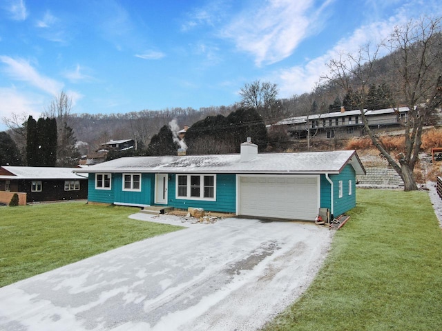 single story home featuring a garage and a front yard