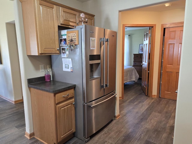 kitchen featuring dark wood-type flooring and stainless steel refrigerator with ice dispenser