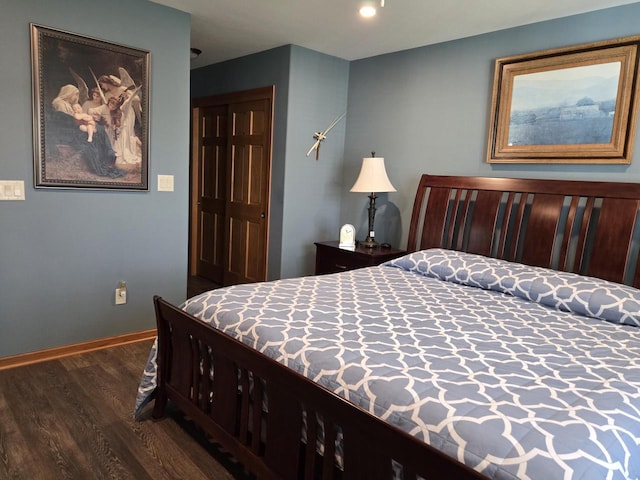 bedroom with a closet and dark hardwood / wood-style flooring