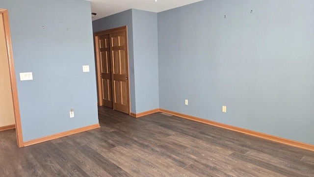 spare room with dark wood-type flooring