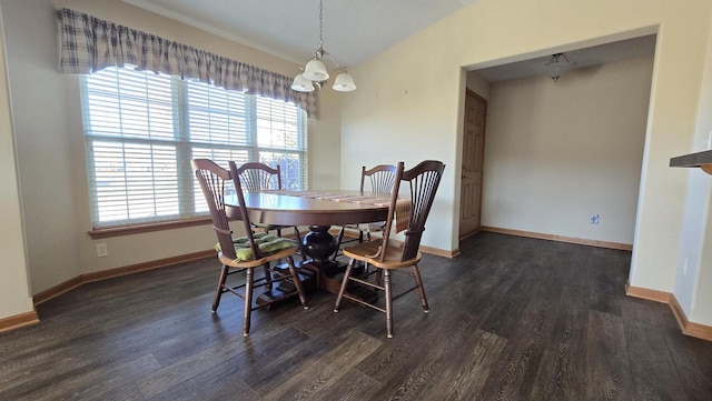 dining room featuring dark wood-type flooring and vaulted ceiling