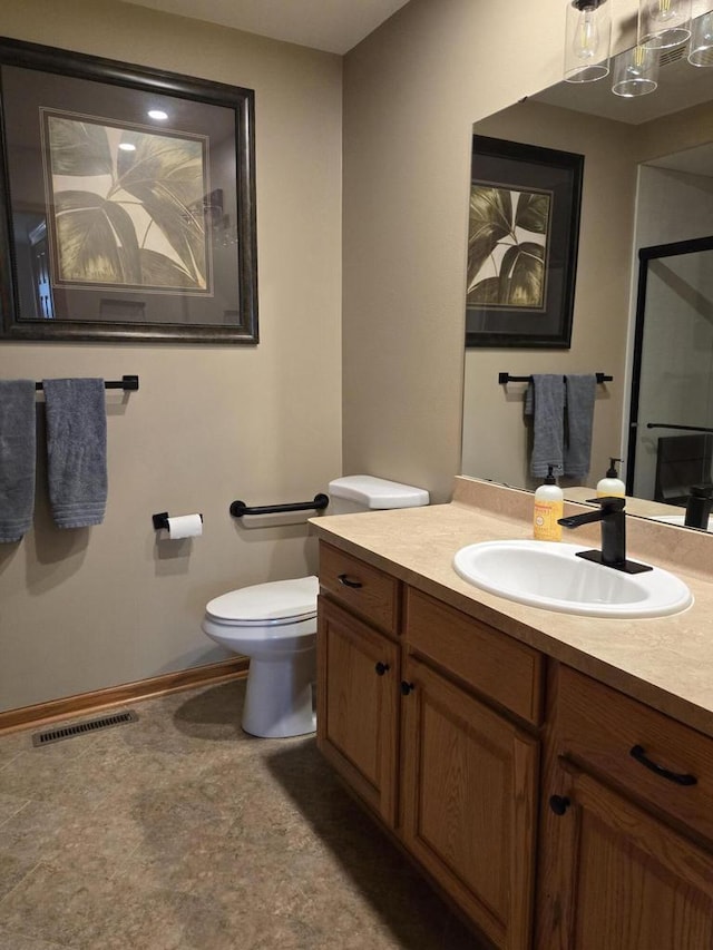 bathroom with toilet and vanity