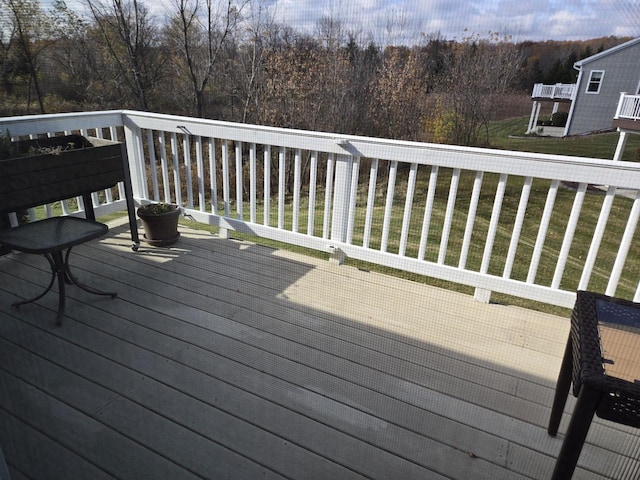 wooden terrace with a yard