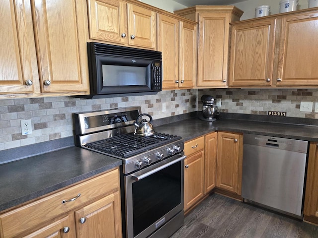 kitchen with backsplash, appliances with stainless steel finishes, and dark hardwood / wood-style floors