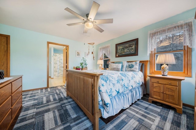 carpeted bedroom with ceiling fan and ensuite bathroom