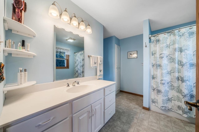 bathroom with curtained shower and vanity