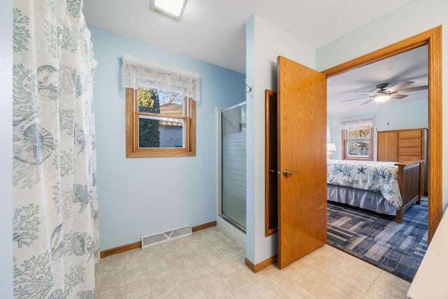 bathroom with ceiling fan and walk in shower