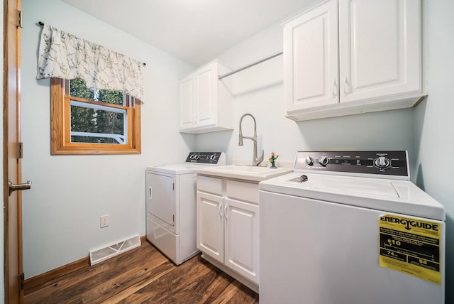 laundry room featuring sink, cabinets, dark wood-type flooring, and separate washer and dryer