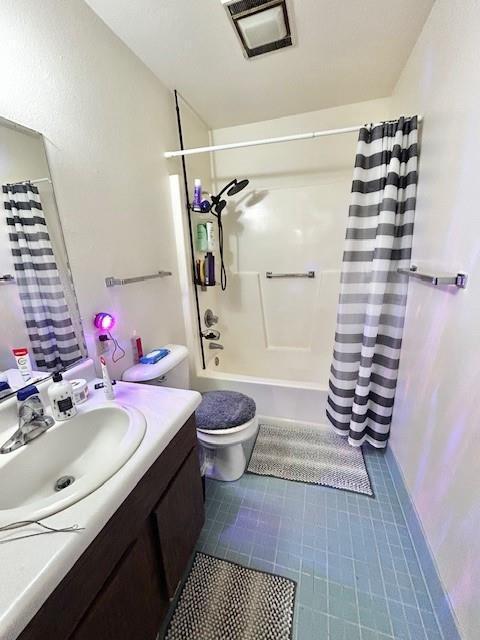 full bathroom with toilet, shower / bathtub combination with curtain, and vanity