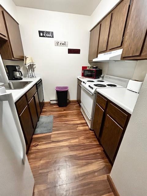 kitchen with sink, dark hardwood / wood-style floors, black dishwasher, white electric range, and dark brown cabinetry