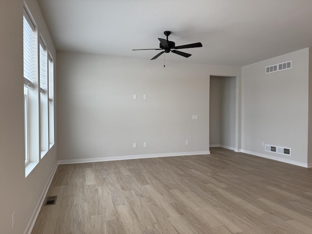 spare room with light wood-type flooring and ceiling fan