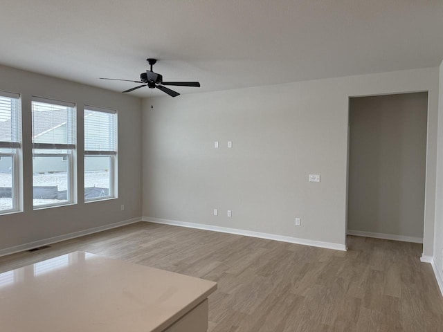 empty room featuring light hardwood / wood-style floors and ceiling fan