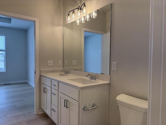 bathroom featuring hardwood / wood-style floors, toilet, and vanity