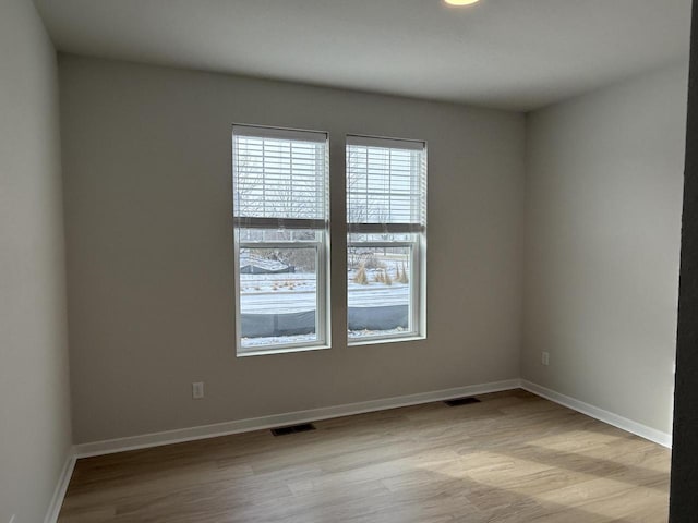 unfurnished room featuring light hardwood / wood-style floors