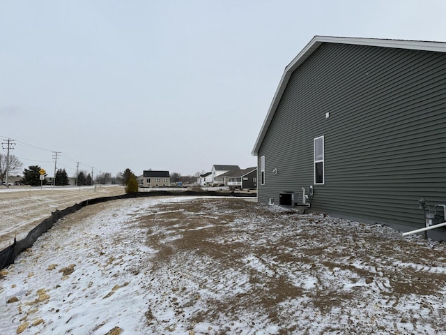 view of snow covered exterior featuring central air condition unit