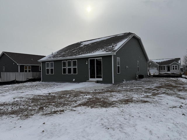 snow covered property with central AC unit