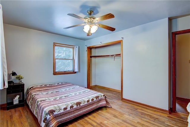 bedroom with ceiling fan, a closet, and light wood-type flooring