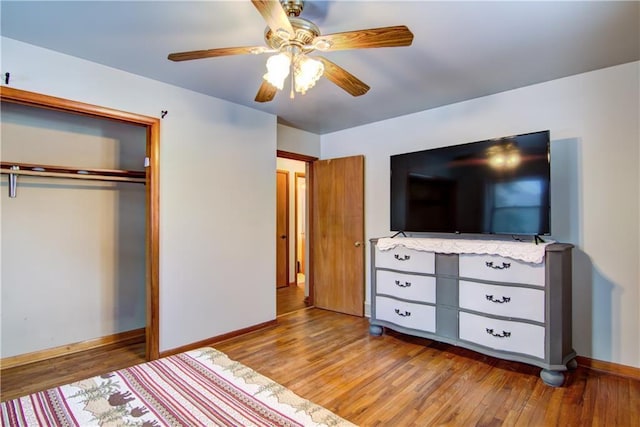 unfurnished bedroom featuring wood-type flooring, a closet, and ceiling fan