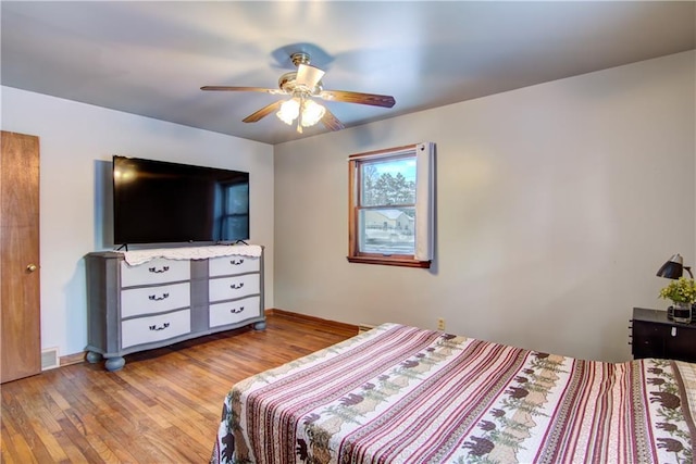 bedroom with light hardwood / wood-style flooring and ceiling fan