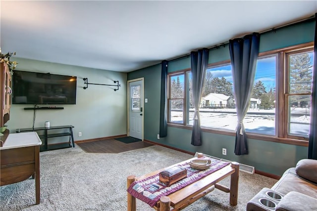 living room with plenty of natural light and carpet flooring