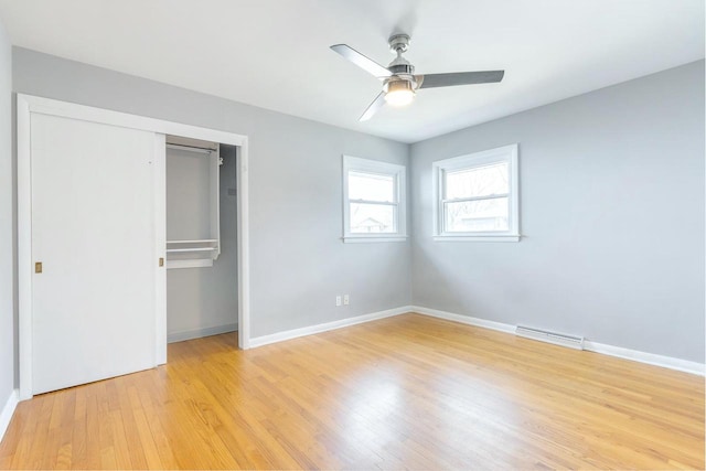 unfurnished bedroom with ceiling fan, light wood-type flooring, and a closet