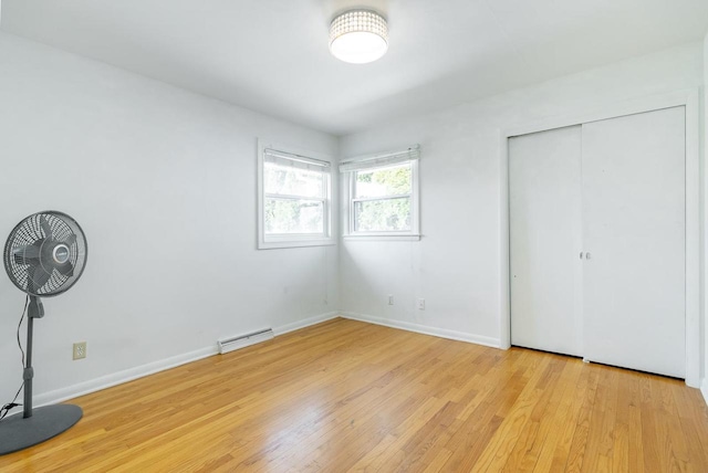 unfurnished bedroom featuring light hardwood / wood-style floors and a closet