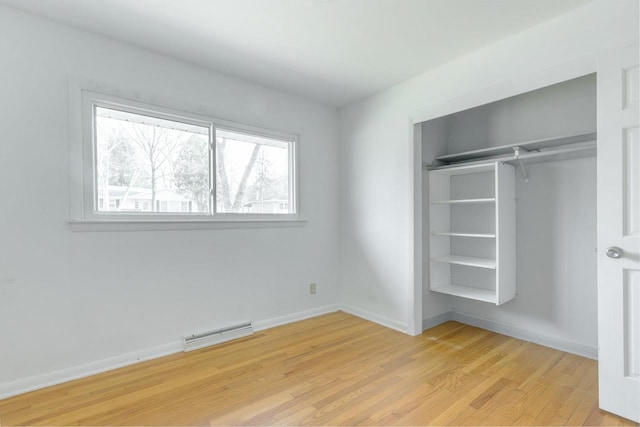 unfurnished bedroom featuring a closet and light hardwood / wood-style flooring