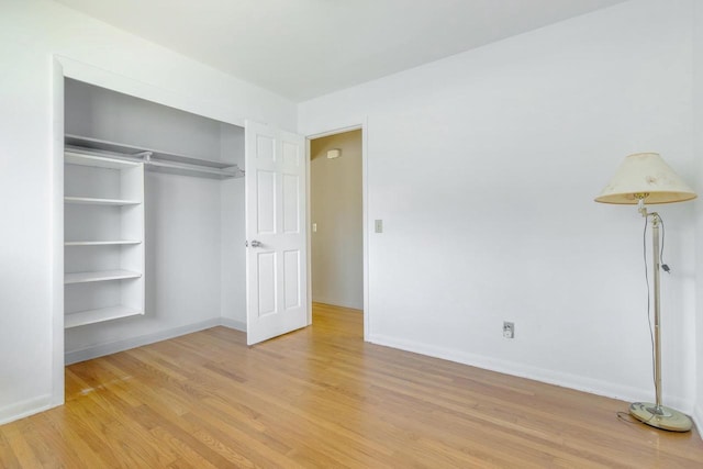 unfurnished bedroom featuring a closet and light wood-type flooring